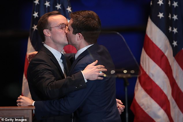 Pete Buttigieg kisses his husband Chasten after a speech in 2020