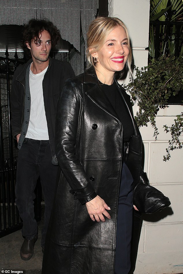 The American-British actress looked effortlessly chic as she opted for a long black leather coat for the evening, which she paired with some tailored navy trousers