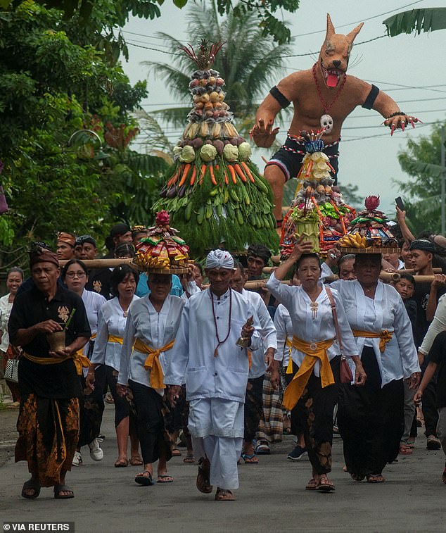 Hindu worshipers parade ogoh-ogoh figures under Ngrupuk the night before Nyepi and make noise to attract evil spirits, who then find the island deserted the following day and leave