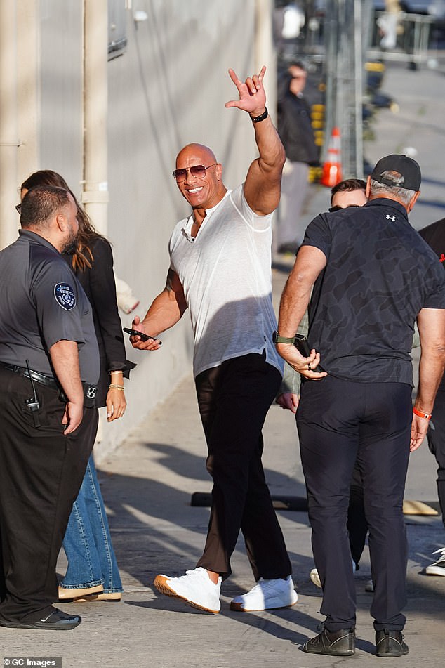 Also prepping was Dwayne 'The Rock' Johnson, 51, who kept it casually cool in a white t-shirt, black slacks and white sneakers