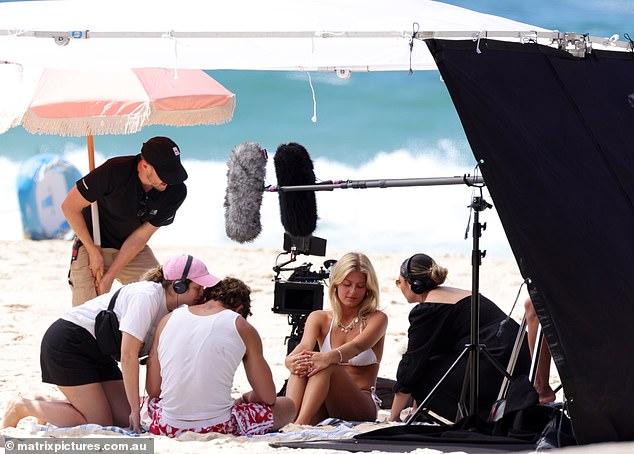 Later, a group of attractive young stars huddled together on a towel surrounded by a camera crew
