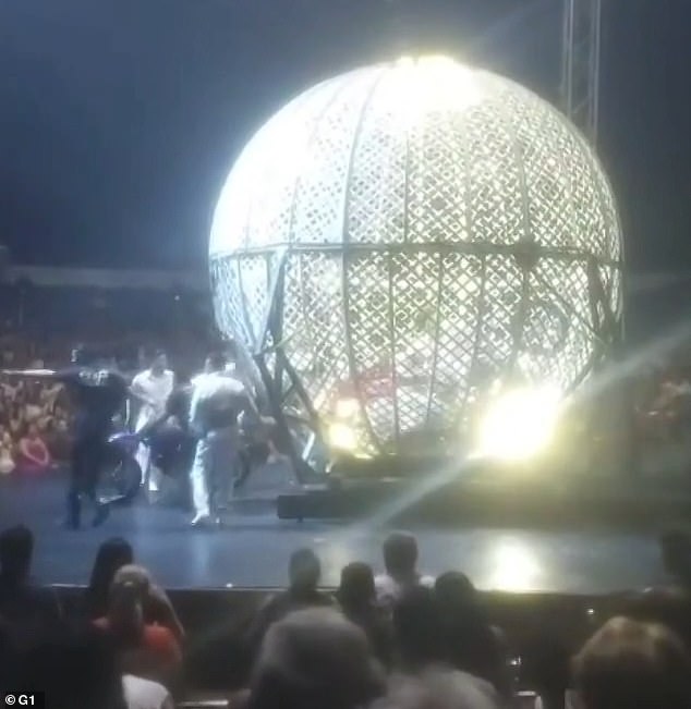 Circus workers rushed to the stage moments after stunt bikers crashed during a Globe of Death display
