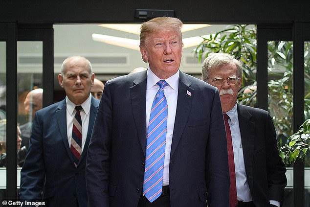 Trump pictured with former chief of staff John Kelly and former national security adviser John Bolton in 2018