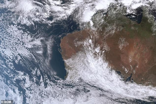 A satellite image from the Bureau of Meteorology shows massive cloud cover over central and southern Western Australia