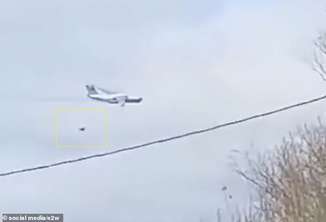 Footage appears to show a large object falling from the plane and crashing to the ground