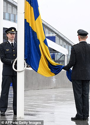 Two soldiers raised the country's flag and cemented its place as a member of NATO on Monday