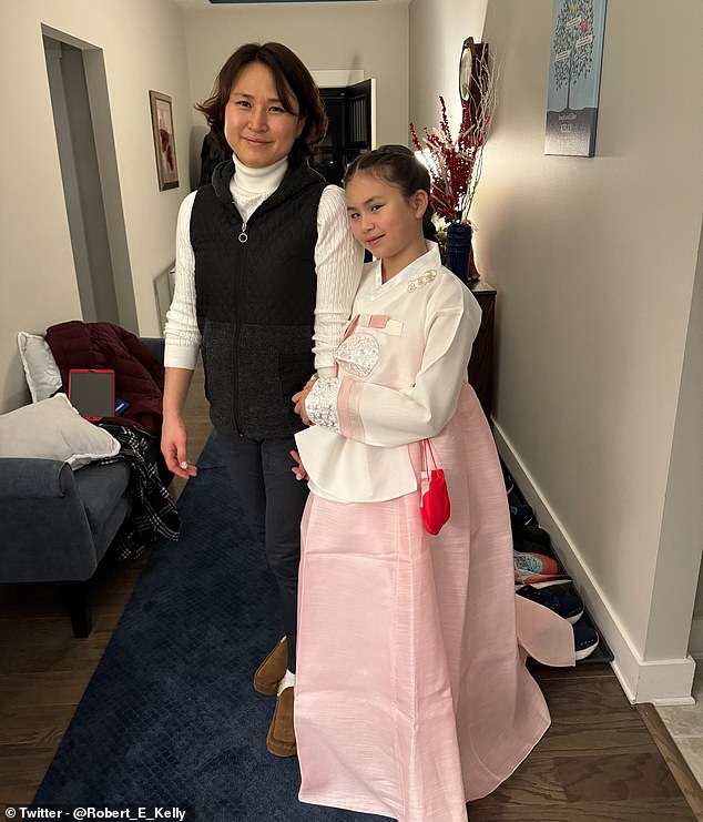 In another photo, Marion can be seen wearing a pink and white hanbok while posing with her mother Jung-a
