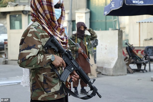 Taliban fighters stand guard at a checkpoint in Kabul, Afghanistan, Wednesday, August 25, 2021.