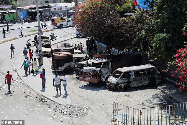 Vehicles set on fire by armed gangs on Monday night are seen outside the Carrefour de l'Aeroport sub-police station of the Haitian National Police (PNH), in Port-au-Prince, Haiti, March 5