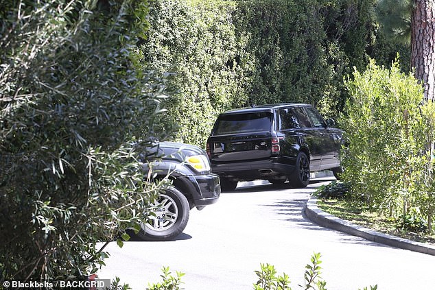 The black Range Rover carries Kelce and his friend on their way to Swift's Beverly Hills mansion