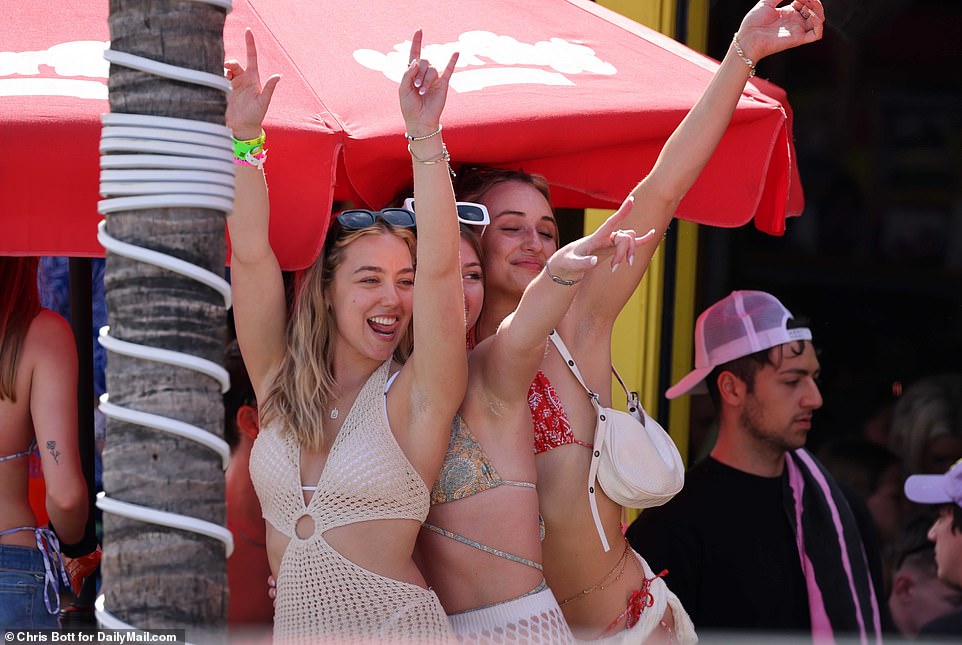 Photographs from the second day of the long holiday show bikini-clad girls partying on the beach and cops patrolling the streets and sand in large numbers - some on horseback