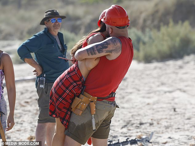 The red team was seen lovingly embracing as one man wrapped his arms around his female companion