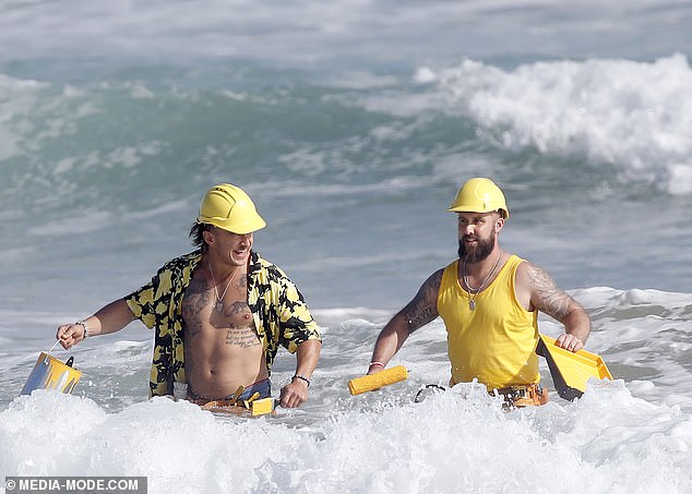 The yellow team, consisting of two strapping men in their late 20s, showed their strength as they confidently waded through the water with paint cans and rollers