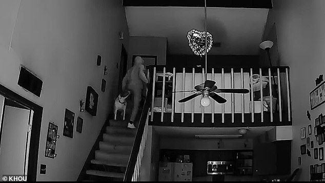 Another camera located inside Evans' house reveals intruders walking up the stairs and into the bedroom