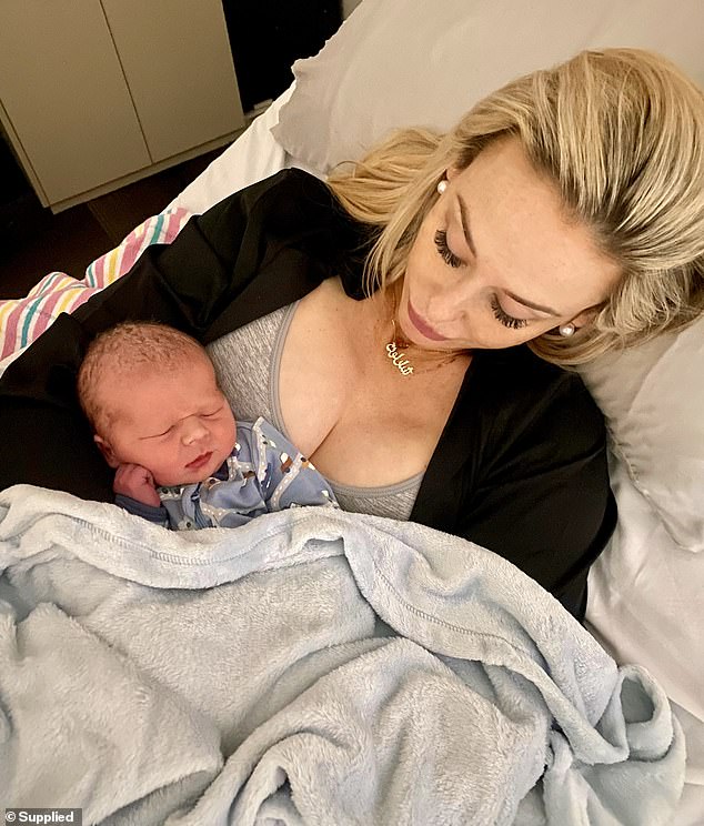 In another picture, Charlotte looks like the proud mother as she tenderly holds Winston in his hospital bed. Pictured