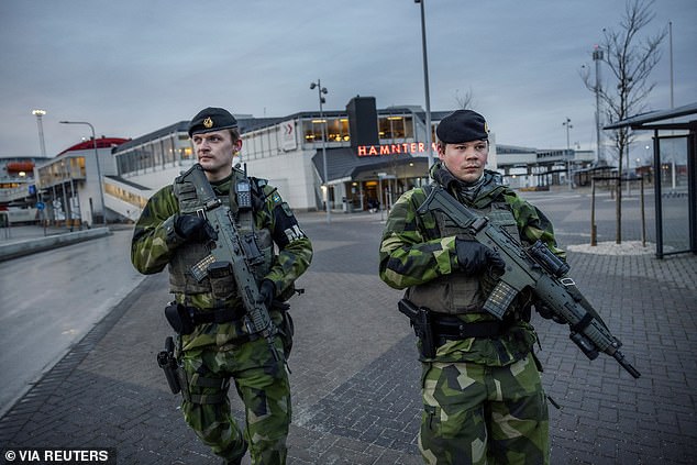 Soldiers from Gotland's regiment patrol Visby harbor amid heightened tensions between NATO and Russia over Ukraine