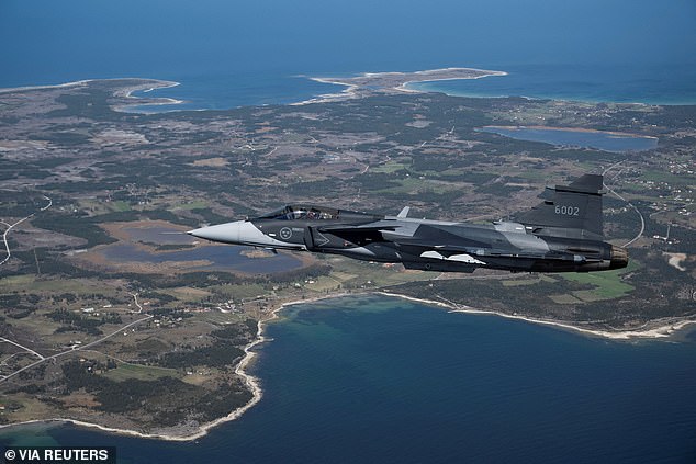 FILE PHOTO: A Swedish JAS 39 Gripen E fighter jet flies over the Swedish island of Gotland in the Baltic Sea, on May 11, 2022