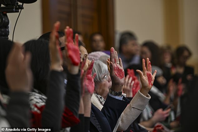 A group of activists staged a pro-Palestinian protest at the House hearing, raising their hands painted red