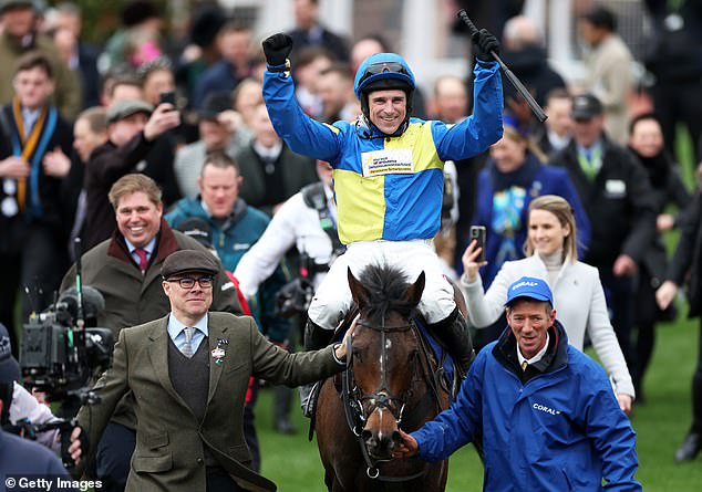 Harry celebrates with Langer Dan after winning the Coral Cup Handicap Hurdle earlier in the day.