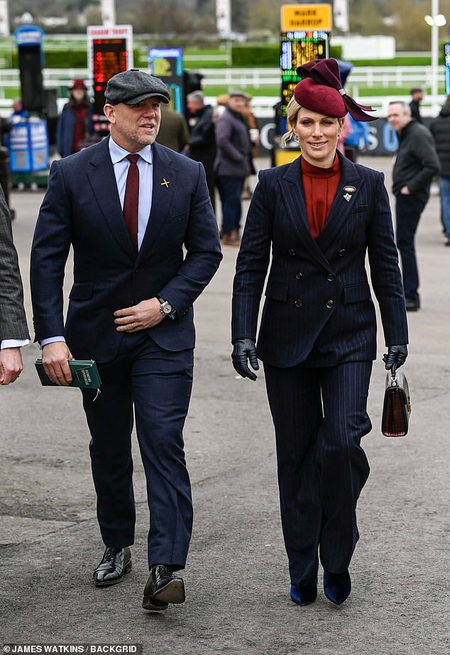 Mike Tindall looked dapper in a navy suit, gray cap and burgundy tie that perfectly matched his wife's fascinator