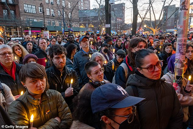 People gather outside the Stonewall Inn for a memorial and vigil for the Oklahoma teenager who died after a fight in a high school bathroom