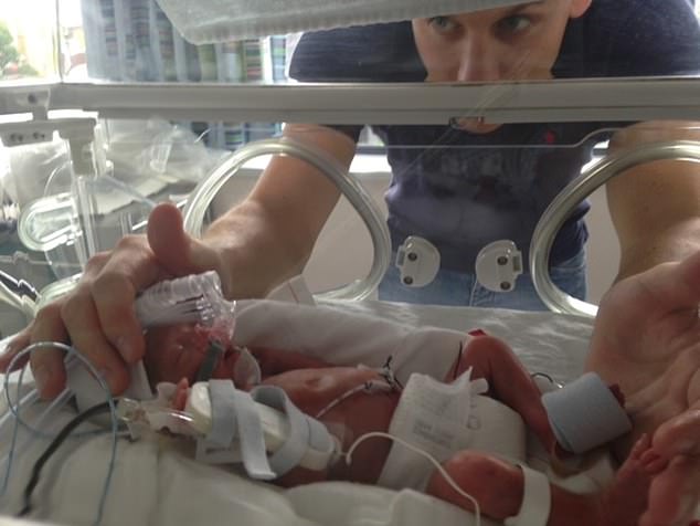 Henry is pictured with his son, Arthur, who was born prematurely at 26 weeks.
