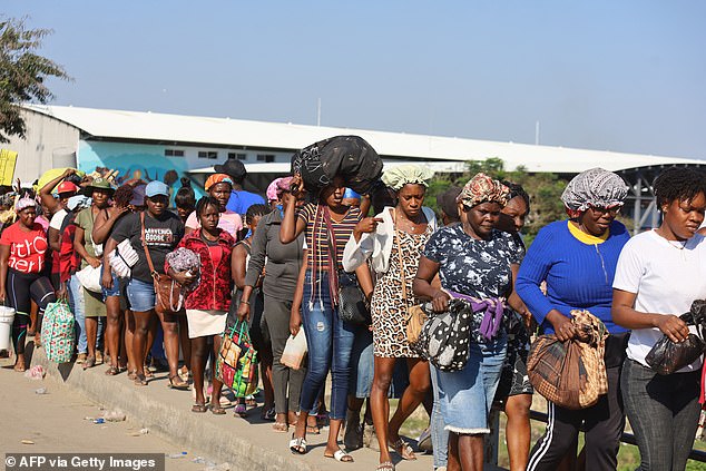Haitians cross the border between Quanamienthe in Haiti and Dajabon in the Dominican Republic, pictured on Friday