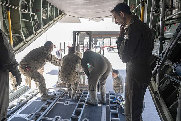 Jordanian airmen load aid bound for Gaza onto a C-130 at King Abdullah II Air Base