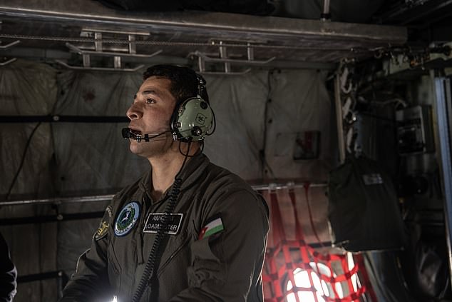 A member of Jordan's Royal Airforce prepares the plane for take-off.  The cargo was dropped on Gaza