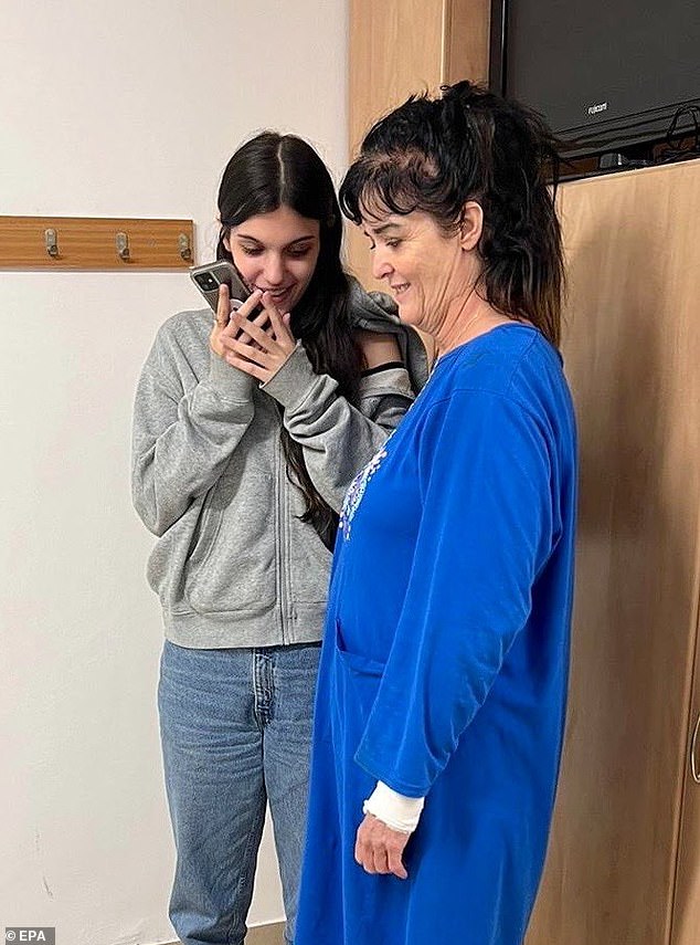 A handout photo made available on October 21 by the US Embassy in Jerusalem on their official X account shows US citizens Judith Raanan (R) and daughter Natalie Raanan (L) talking on the phone with US President Joe Biden (not pictured) following their release after being abducted by Hamas in Israel early on October 21, 2023