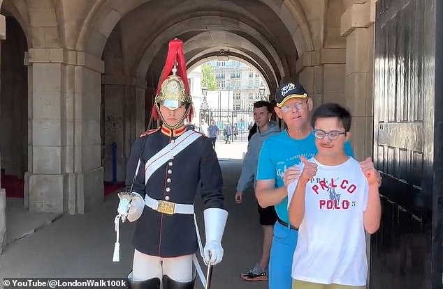A member of the King's Guard won praise after going out of his way to make a young man with Down syndrome feel comfortable after moving closer to him as he posed for a picture