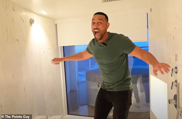 Matt is clearly delighted with his suite's bathroom, which features a hot tub on the balcony.