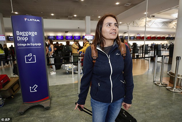 Passenger Janet Baker prepares to check in at Auckland International Airport in New Zealand for a rescheduled Latam Airlines flight to Santiago, Chile on Tuesday, March 12, 2024