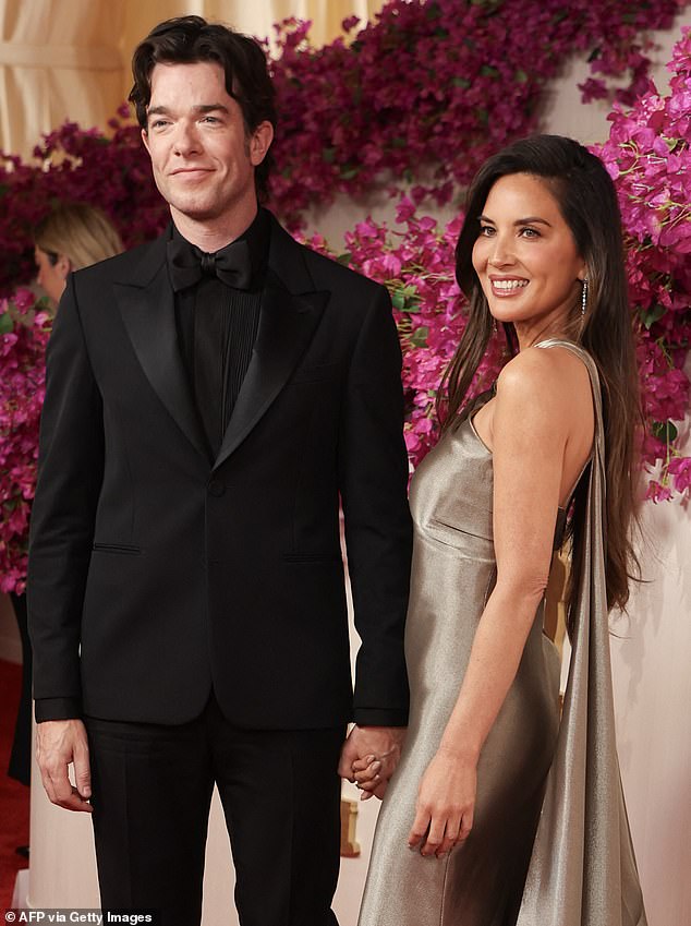 Olivia, who attended the 2024 Oscars at the weekend with John Mulaney (pictured), thanked him for 'the nights he spent researching what every operation and medication meant'