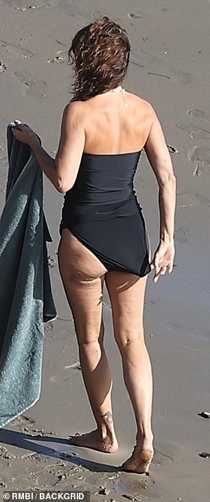 The Danish stunner made an adjustment to her swimsuit between takes