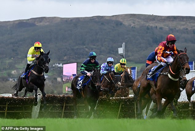 Harry Cobden (left) led Monmiral to victory in the Pertemps Handicap Hurdle at odds of 25/1