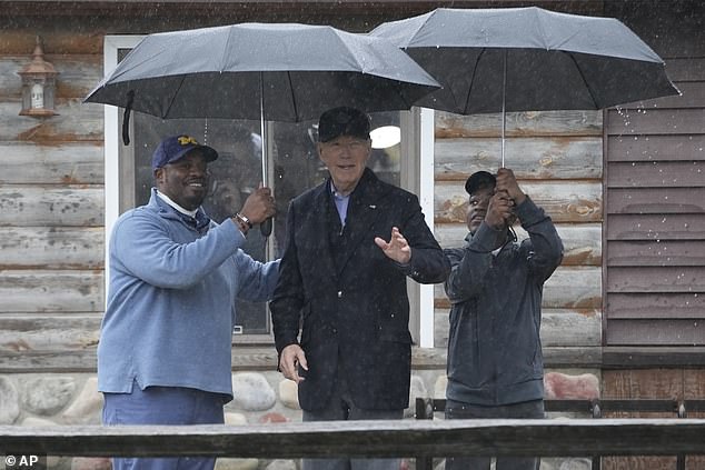 President Joe Biden poses for a photo with Hurley 'HJ' Coleman IV (right) and his father Hurley Coleman III (left) at Pleasant View Golf Club in Saginaw, Michigan. It is the second time the president has held a private meeting this week with a family in a key swing state