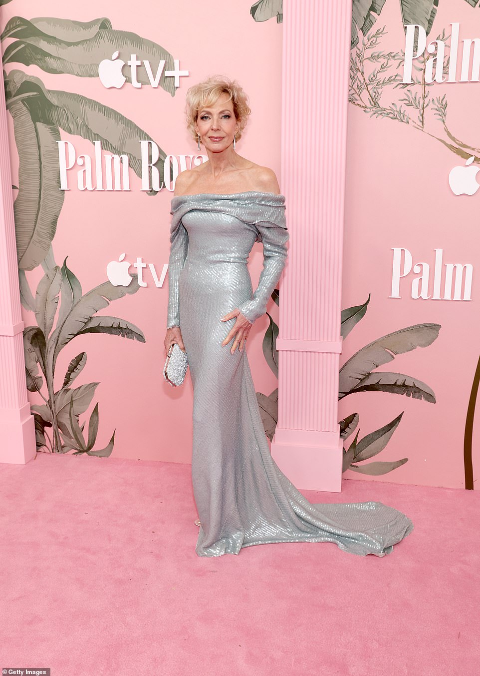 Allison Janney showed off her tiny waist in a sparkling silver sequined off-the-shoulder dress with an elegant train