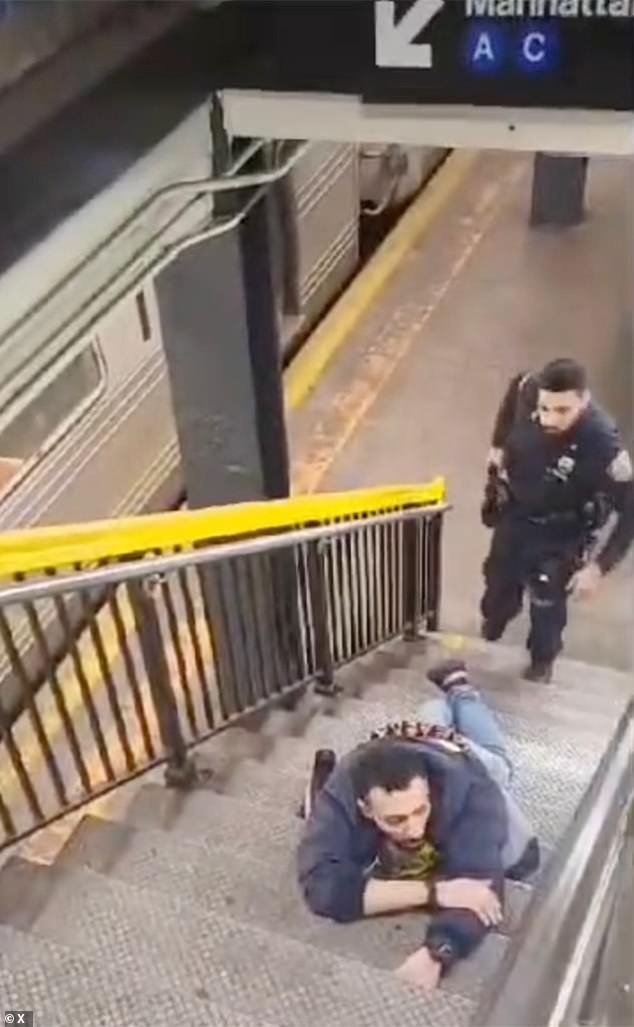 The 32-year-old shooter was arrested before he entered the platform and remained in custody. He is seen lying on the steps outside the subway car