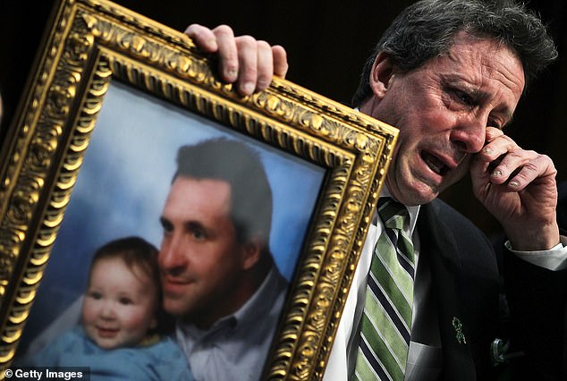 Neil Heslin, father of six-year-old Sandy Hook Elementary School shooting victim Jesse Lewis, wipes away tears as he testifies at a Senate Judiciary Committee hearing