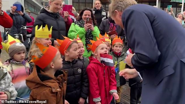 During a royal engagement in Zutphen, one of the country's oldest cities, the monarch was speaking to a crowd of schoolchildren dressed in paper crowns when a young girl told him about a photo of him with his entire family