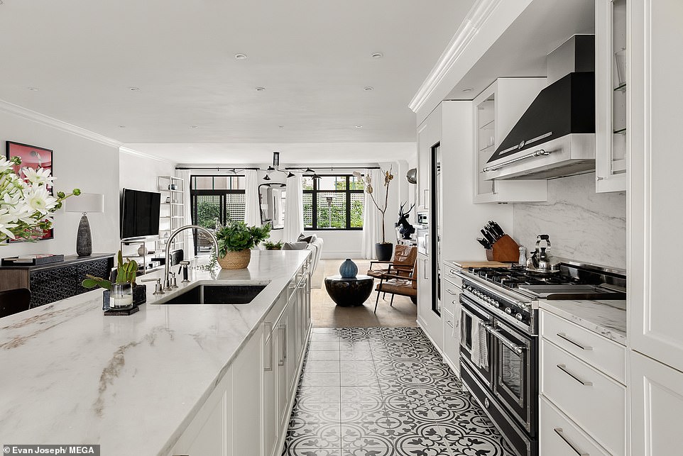 Crisp white SieMatic cabinetry complements the Imperial Danby marble countertops with Bertazzoni six-burner, double oven range and top-of-the-line refrigerator
