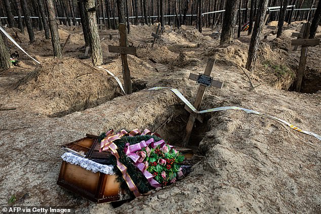 (FILES) This photo shows an empty coffin after the exhumation of bodies in mass graves dug during the Russian occupation in the city of Izium, eastern Ukraine, on January 2, 2023.