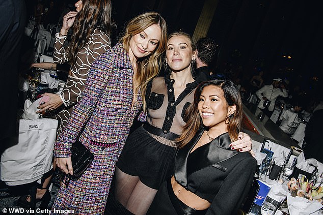 The actress, who recently celebrated her 40th birthday, wore a plunging multicolored bouclé dress to the event (pictured with a guest and Jen Rubio, R)