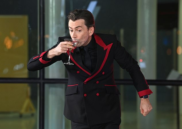 Pairing the smart jacket with an all-black suit, the Doctor Who star enjoyed his martini, shaken without stirring, as he fully embraced the character
