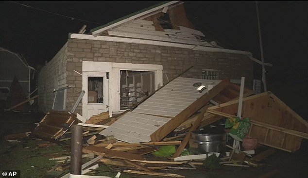 The storms tore through the Midwest on Thursday. Pictured: Damage from a severe weather system is seen in Lakeview, Ohio,