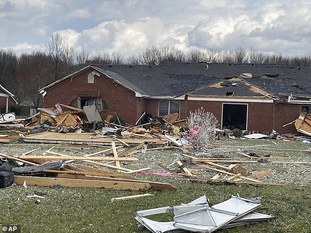 Debris covers the ground in front of a damaged home after severe weather passed through the area Thursday, March 14, 2024, in Jefferson Manor Subdivision near Hanover, Indiana