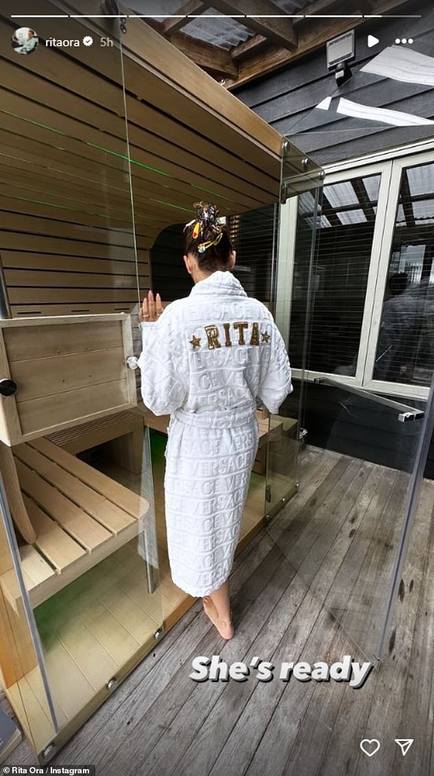 She posed for snaps as she headed into an infrared sauna at Found Space before donning a personalized dressing gown with her name embroidered on the back
