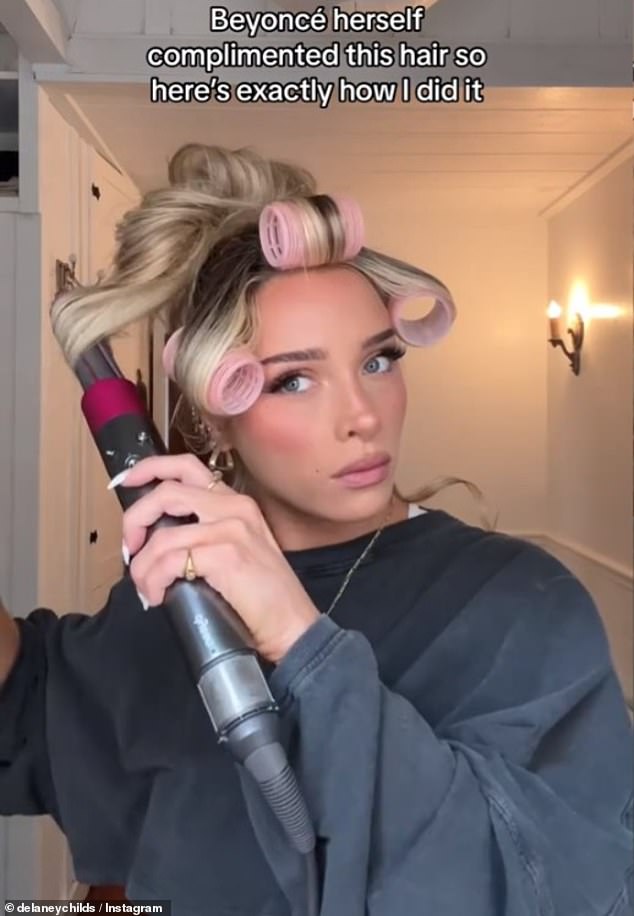 Delaney uses a Dyson Airwrap to curl the front section into bangs before putting the hair into large rollers which she wraps against the face and hairspray to keep them from tangling