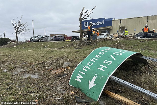 Emergency crews and residents gather around Winchester, Indiana, Friday morning after severe weather hit the area Thursday night.  The roof of a Goodwill location off Indiana Highway 27 was torn off and its walls were shredded